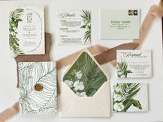 wedding stationery with tropical leaves and flowers