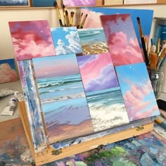 several paintings are being displayed on an easel