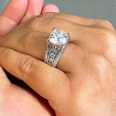 a person holding an engagement ring in their hand