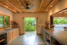 an open kitchen and dining area with sliding glass doors leading to the outside pool side