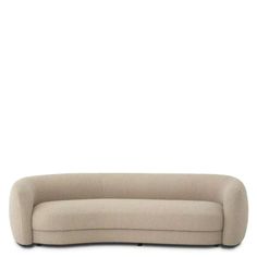 a beige couch sitting on top of a white floor