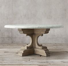 a white marble table sitting on top of a wooden floor