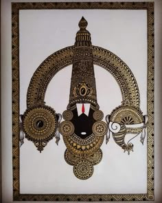 an intricately designed wall hanging on the side of a white wall with gold trim