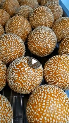 buns with sesame seeds are on display in a store