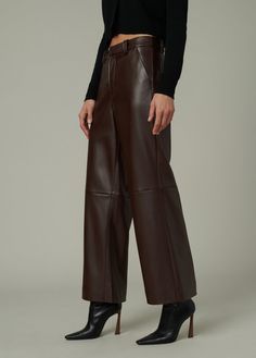 Slim fit through the waist and hips with a high rise and a wide leg that hits right above the ankle. DETAILS + FIT High Rise: 11.5” Wide Leg Zip fly Trouser-pocket styling Leg opening: 23" Ankle length: 28” inseam Soft vegan leather with added stretch for comfort. 100% Vegan leather with polyester backing Hand wash Turn the jeans inside out to protect the fabric from abrasion. Lay them flat in the sink or bathtub and rinse thoroughly with cold water to remove all suds. Spot clean when needed wit Fabric Pants, High Waist Brown Leather Pants, Casual High-waist Brown Leather Pants, Trendy High-waisted Brown Leather Pants, Brown Wide-leg Leather Pants With Pockets, High-waisted Brown Leather Pants, Shirt Jacket Men, Crop Top Sweater, Maternity Tops