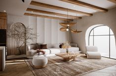 a living room with white couches and wooden ceiling beams in the middle of it