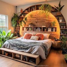 a large bed sitting under a window next to a wooden shelf filled with plants