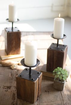 three candles sitting on top of wooden blocks