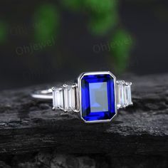 This is a lab blue sapphire engagement ring in solid gold,about 7x9mm emerald cut.  The accent stones are moissanites. The band width is about 1.4mm. It can be made in any ring size. However please contact me to custom make it to a special big or small size. It can be made in white gold,rose gold or yellow gold with 14k or 18k. However for some people who are nickel allergic,I can also make it to 925 sterling silver to make you can wear it. The ring is handmade,very high quality! 30 days money b Sapphire Engagement Ring White Gold, Wedding Ring Women, Blue Sapphire Engagement Ring, Band Necklace, Emerald Cut Engagement, Engagement Ring White Gold, Sapphire Engagement Ring Blue, Ring White Gold, Sapphire Engagement Ring