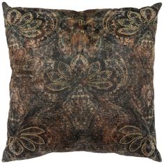 a brown and black pillow with decorative designs on the front, sitting on a white background