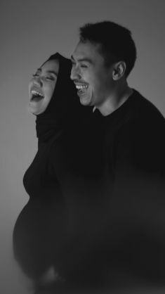 black and white photo of two people laughing