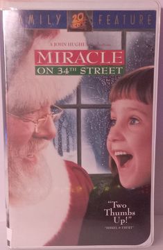 a dvd cover for the movie miracle on 34th street with santa clause and child smiling