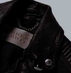 a black leather jacket with a label on the collar and cuffs that say beer birth