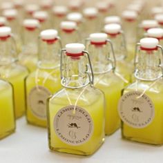 small bottles filled with yellow liquid sitting on top of a table