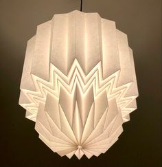 a white paper light fixture hanging from a ceiling