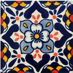 a blue and yellow tile with an orange flower on it