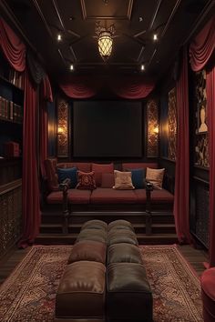 a living room with red curtains and couches in front of a projector screen