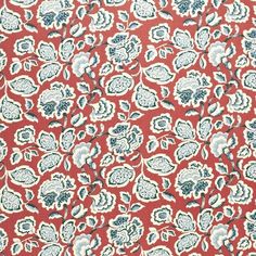 an orange and blue paisley print fabric with white flowers on it, in the middle