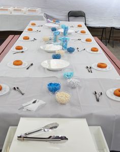 a long table is set with plates and silverware