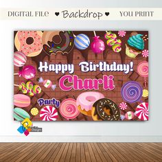 a happy birthday card with donuts and candies in the background, on a wooden floor