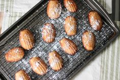 powdered sugar covered pastries on a cooling rack