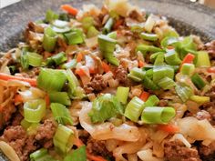 a bowl filled with meat and vegetables on top of a table