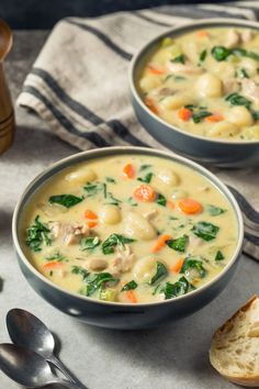 two bowls of chicken and dumpling soup on a table