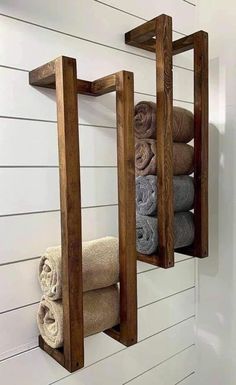 two wooden shelves holding towels and folded towels