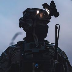 a man with a light on his head and some lights in his hand is wearing a helmet