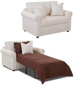 two white couches sitting next to each other in front of a brown and white bed