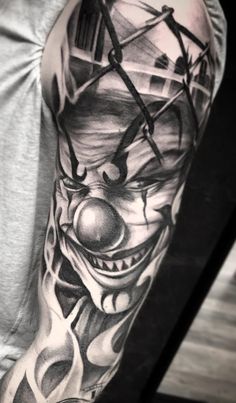 a man's arm with a clown face and clock on the top of it