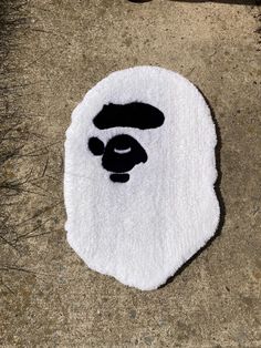 a white rug with a black face on it