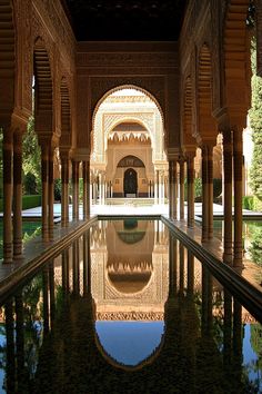 an ornate building with a pool in the middle