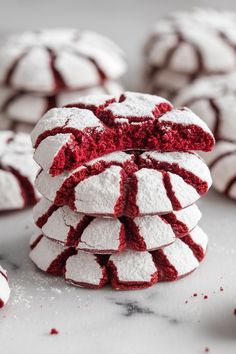 red velvet cookies stacked on top of each other with powdered sugar around the edges