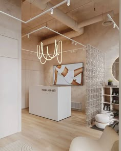 an empty room with a white counter and some lights hanging from the ceiling above it