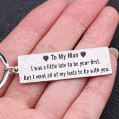 a hand holding a keychain that says to my man i was a little late to be your first but i want all of my lasts to be with you