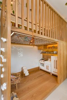 a kitchen with white appliances and wooden stairs