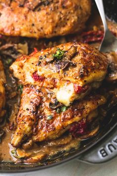 a close up of some chicken on a plate with broccoli and sauces