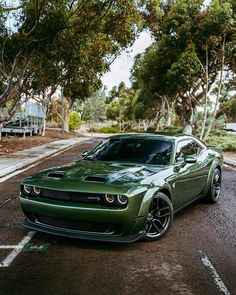 a green sports car parked in a parking lot