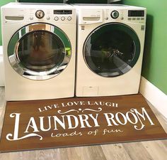 two washers sitting next to each other in front of a laundry room door mat