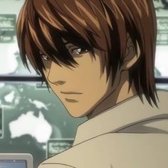 an anime character with brown hair and white shirt looking at something on his computer screen