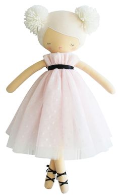 the doll is wearing a pink dress and black shoes