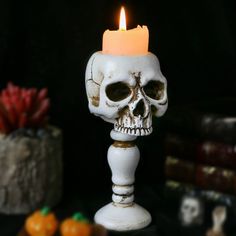 a white candle with a skull on it