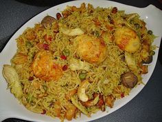 a white plate topped with fried rice and vegetables