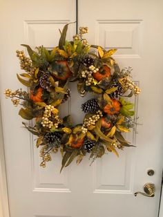 a white door with a wreath on it