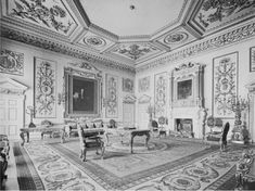 an old photo of a living room with couches and chairs