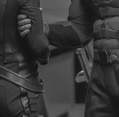 black and white photograph of two men in leathers with their hands on each other's back