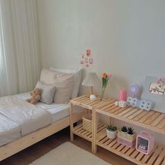 a bed room with a neatly made bed and a wooden shelf next to the bed