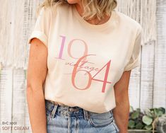 "Classic 1964 Shirts For Women, Vintage 60th Birthday Year Number Tshirt For Him, Cute 60th Milestone Best Friend 60 Bday T-Shirt For Her HOW TO ORDER ➀ Select color ➁ Select the size (Please check size chart) ✦ True to size. Size up 1-2 sizes for an oversized look. ➂ Add to cart ✦ (Optional) \"Add message to Seller\" on the checkout page. GARMENT FEATURES ✦ Crew neckline ✦ Direct to garment printing - no vinyl, decal, or iron-on technique ✦ Our designs are printed on the garment to last a long time and may not appear as 'glossy' or saturated as iron-on designs are. ✦ Please note that colors may appear different on different digital screens and may not be a true representation of the actual colors. ✦ Additional T-Shirt Colors and Sizes Available Upon Request ✧✧Brands: Bella Canvas Unisex 3 Shirts For Women, 60th Birthday, Women Vintage, Comfort Colors, Crew Neckline, Best Friend, Vintage Ladies, Vinyl Decal, Colorful Shirts