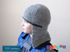 a child wearing a crocheted hat with a hood on it's head